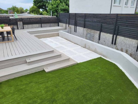 A stunning garden deck with a lush green lawn.