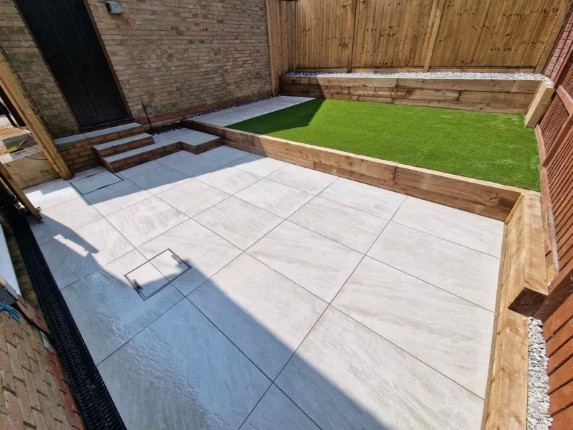 A well-defined garden edge with wooden beams.
