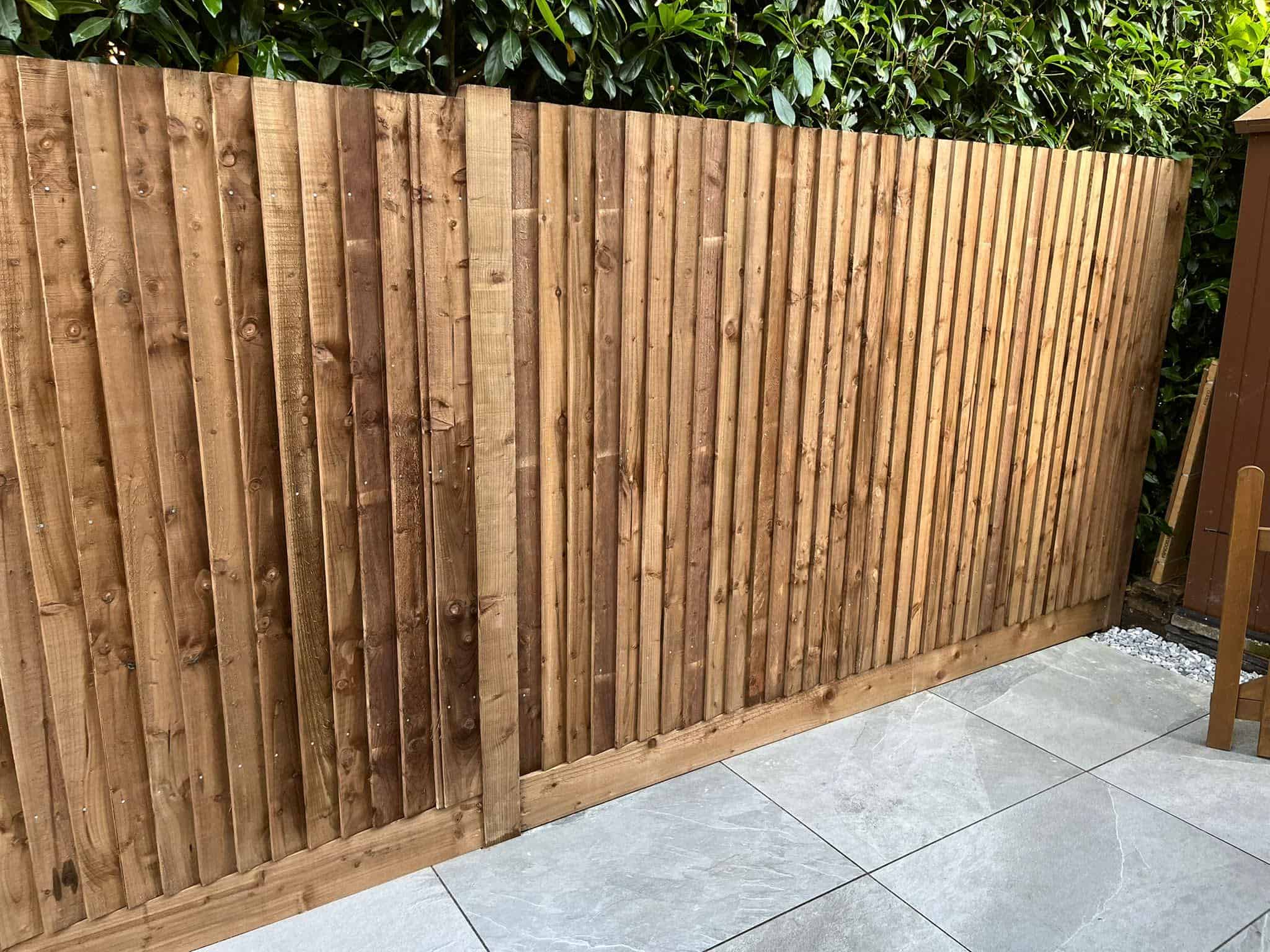 A wooden fence with a natural finish, providing privacy and security.