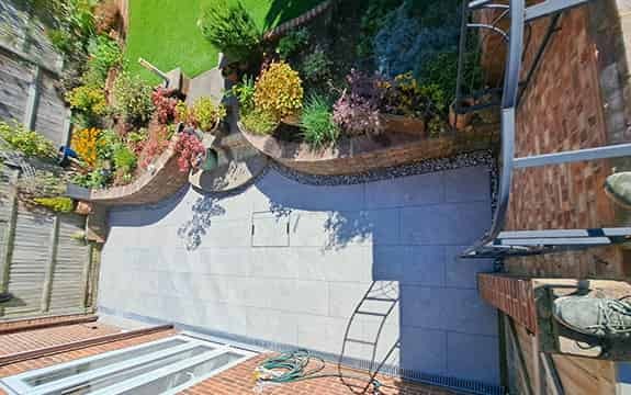 An arial shot of a vibrant flowerbed in full bloom, showcasing a variety of plants and colors.